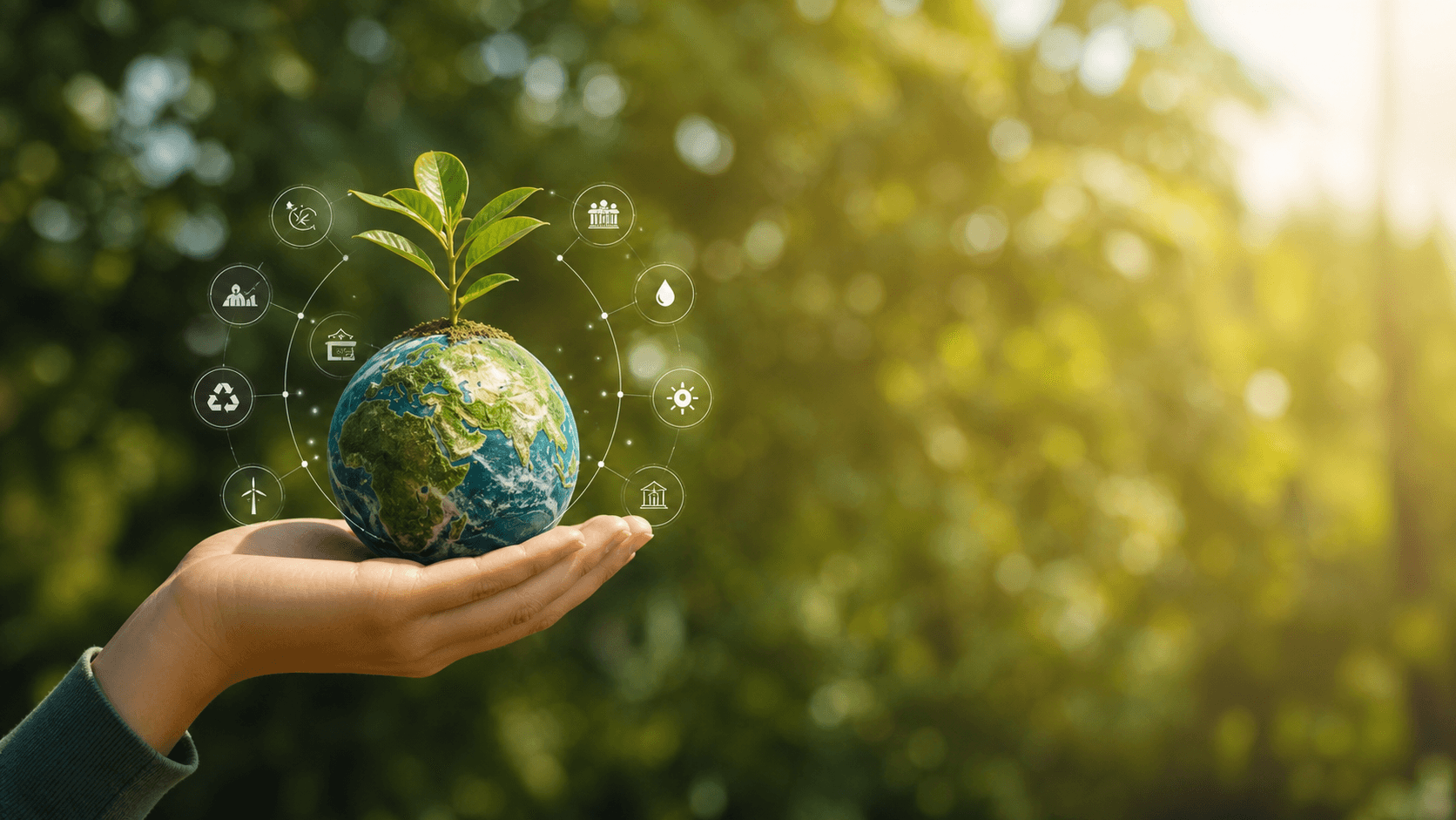 Hand holding a globe with a young plant and eco technology icons