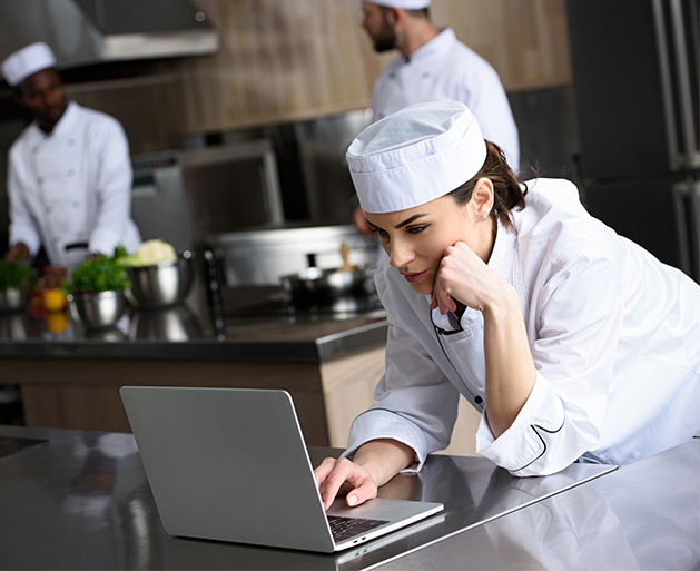 A chef using American PaySave POS technology for better kitchen communication