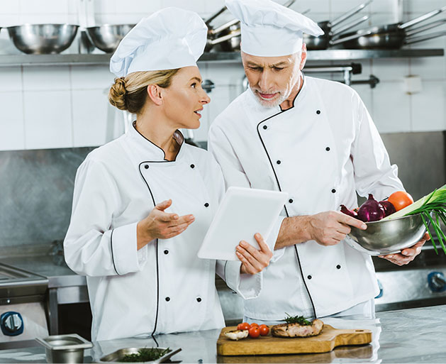 Chefs at a fine dining restaurant using American PaySave POS systems to manage their inventory