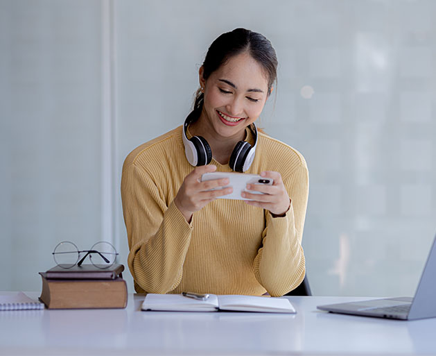A female gamer easily updating her account information using American PaySave merchant services