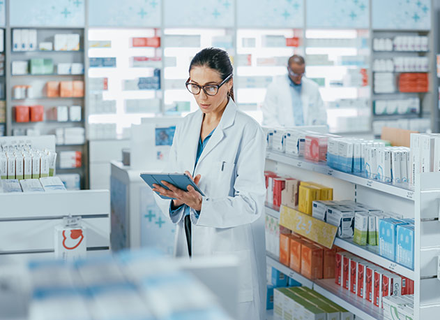 A pharmacist taking inventory using American PaySave's inventory management systems
