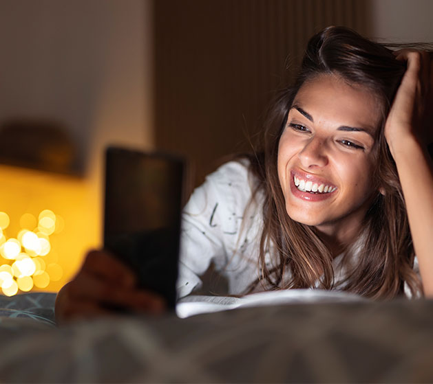 A woman using an online dating app powered by American PaySave software