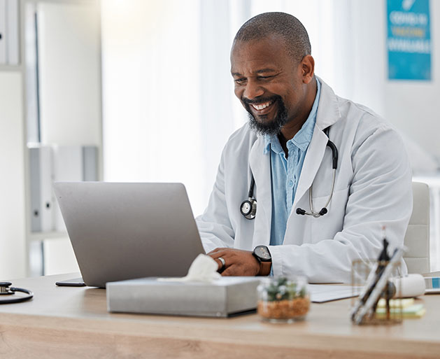 A doctor reviewing telemedicine reports using American PaySave POS software 
